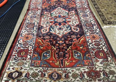 multiple rugs being professionally restored