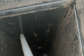 Close up of air duct cleaning service in progress